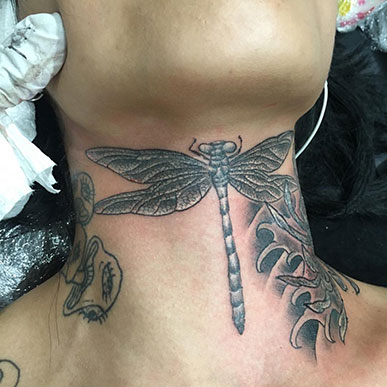 Figure 4. Hand-poked dragonfly neck tattoo by Horitsuna (Tattoo Studio Desperado).