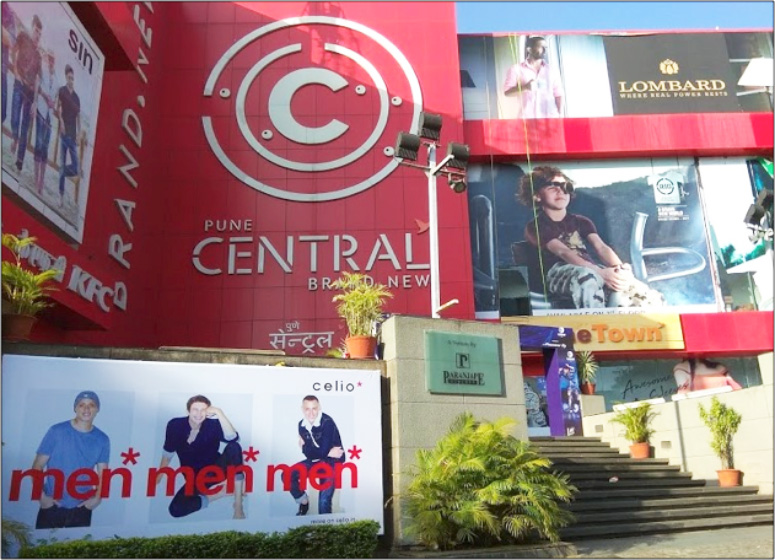 Entrance to a mall in Pune called central with advertisements for men's clothing