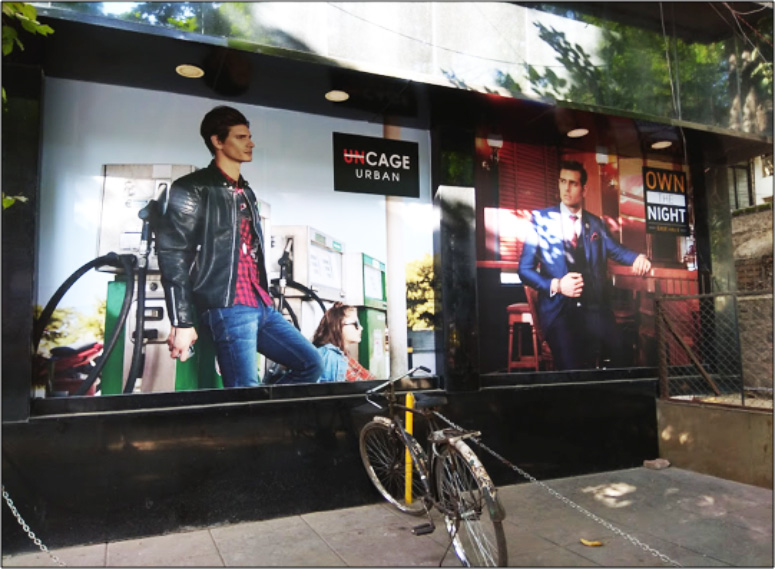 Two advertisements outside of a high-end men's clothing store
